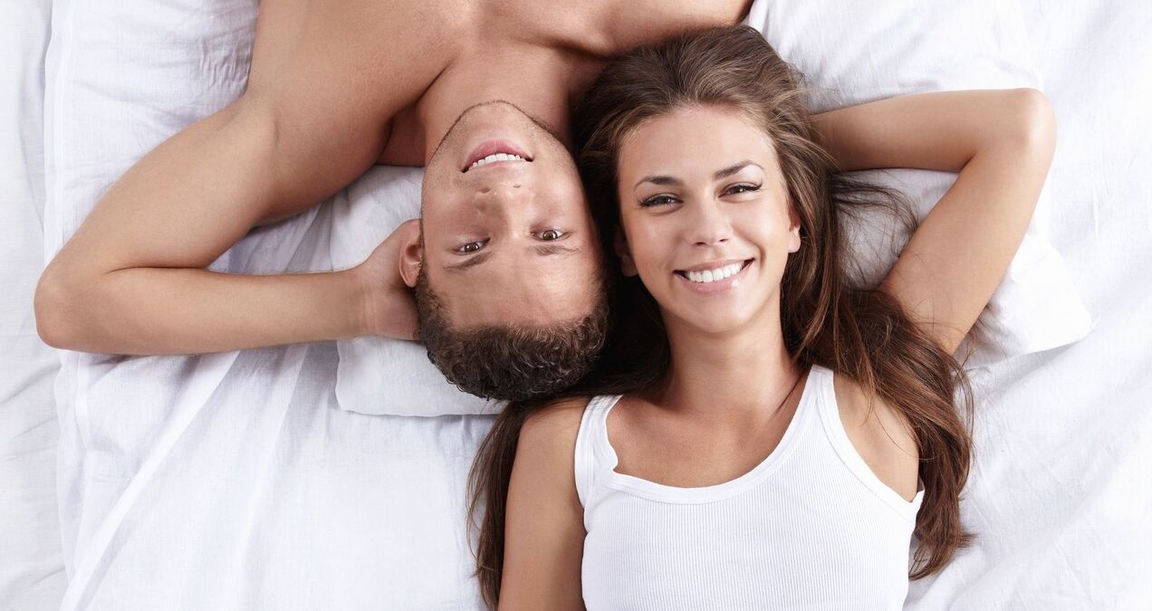 Woman in bed with a man who has increased potency