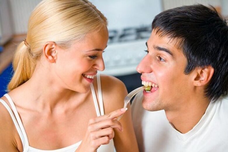 Woman feeds man products to stimulate potency